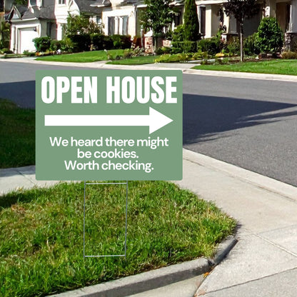 Open house sign with humorous text on a suburban street.