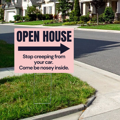 Open house sign with humorous text on a grassy lawn.