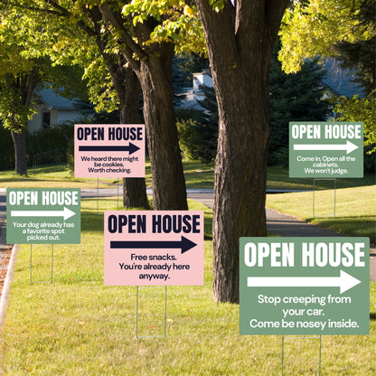 Collection of open house signs in a neighborhood setting with trees and houses in the background.