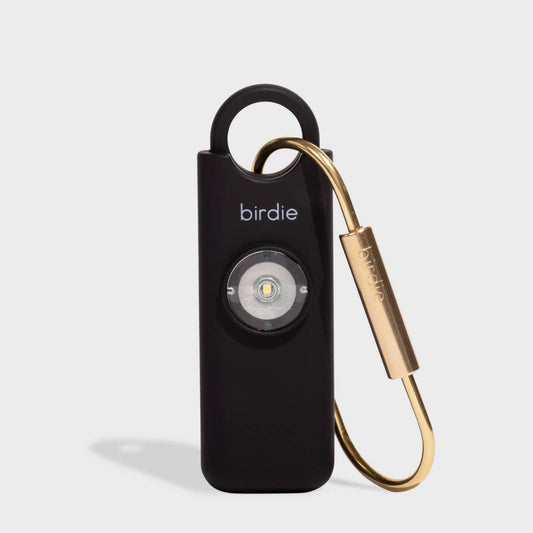 A black personal safety alarm with a gold-colored keychain and branding 'Birdie' on the front.